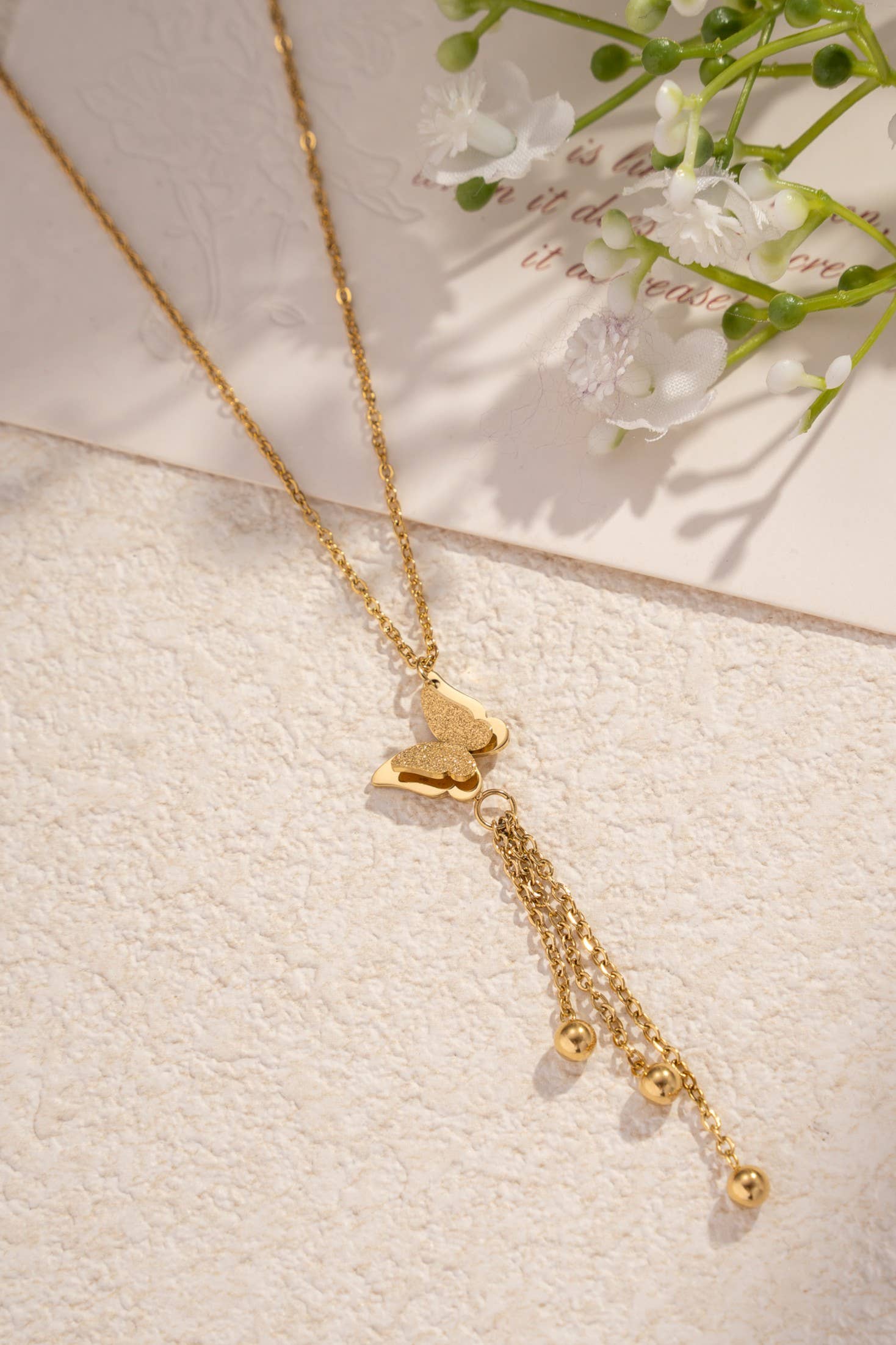 Collier papillon doré en acier inoxydable avec pampilles