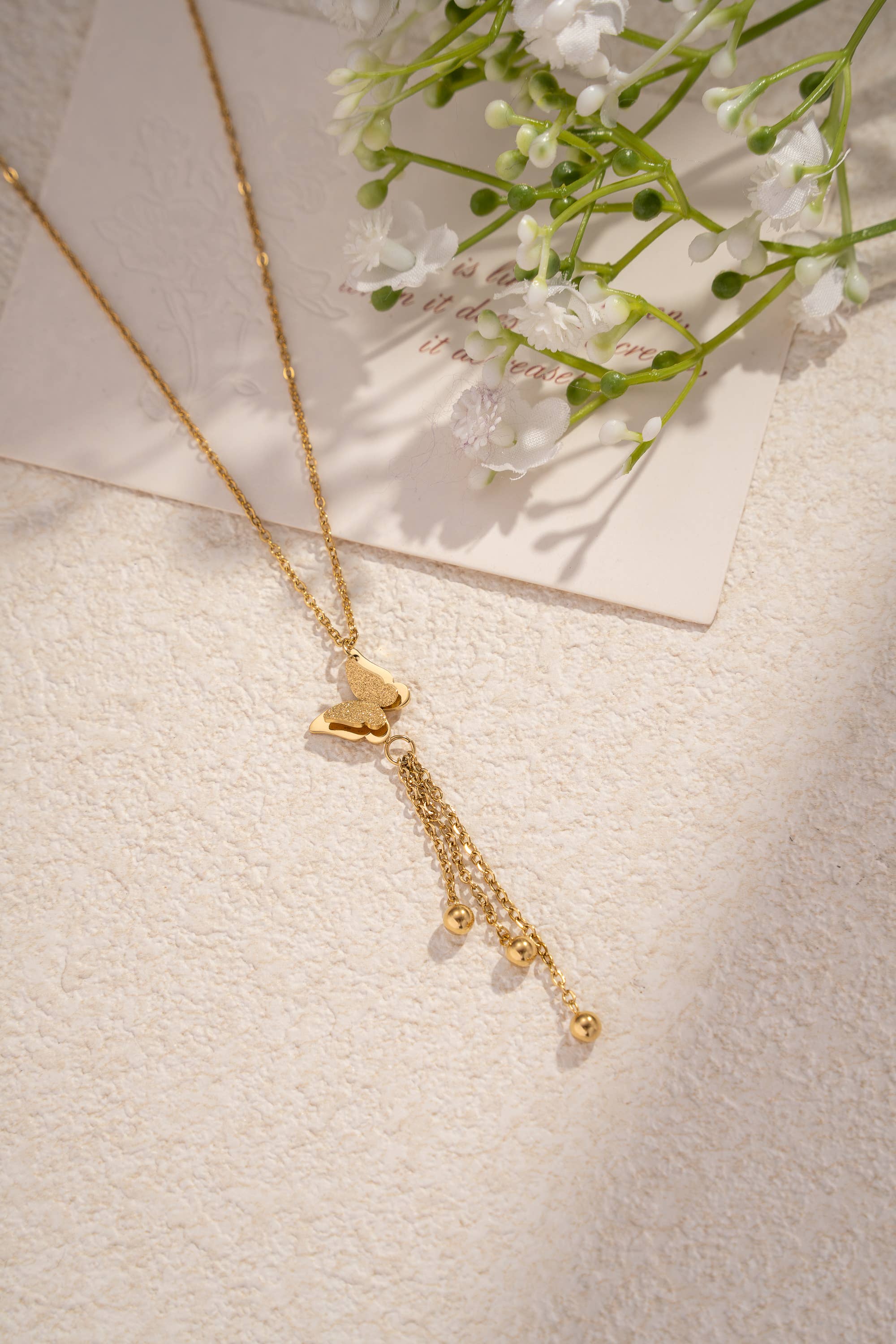 Collier papillon doré en acier inoxydable avec pampilles